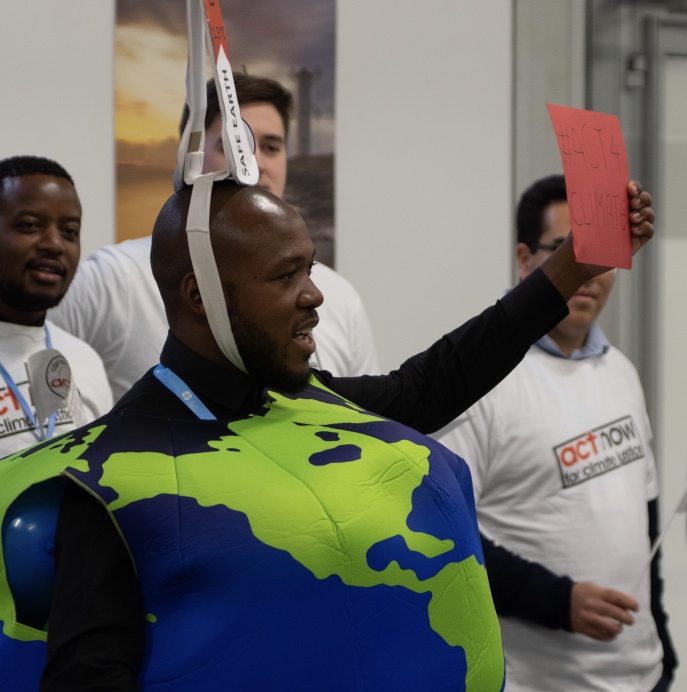 What suits the Earth suits us - Khulekani Magwaza of SAYCCC at COP24 last December, "Our message was that the earth is sick because of temperature increase (indicated by cardboard on my heard). Key asks in this stunt included demonstrating that we need more and better climate finance, inclusion of gender in discussions, rights based adaptation plans, and low carbon development."